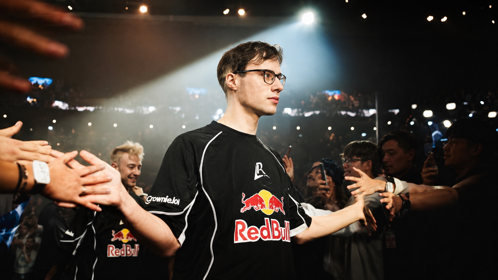 Tournament player walking through an esports arena crowd under championship stage lights.